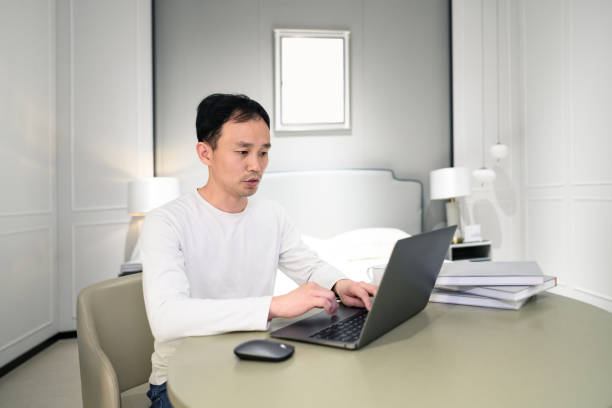istock A young white-collar man works at home on his laptop 1387627921