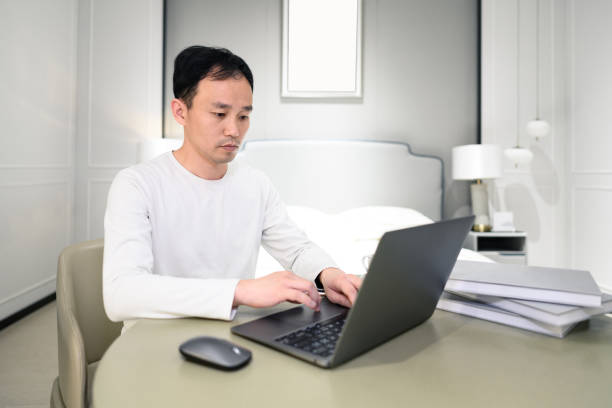 istock A young white-collar man works at home on his laptop 1387628042