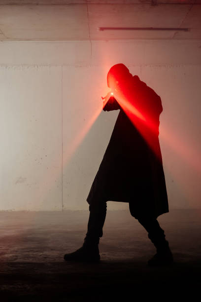 istock Shadow of a man holding laser 1387629532