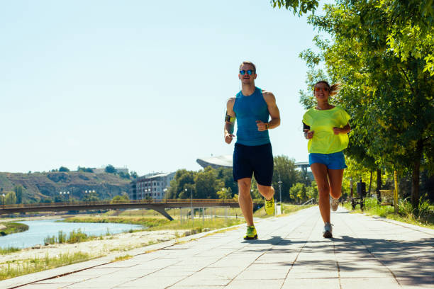 istock Young sport couple jogging on the riverside 1387630843