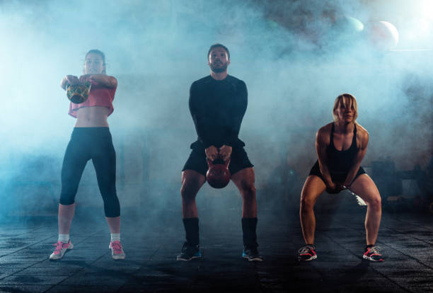 istock Young fitness people exercise with kettle bell 1387631057