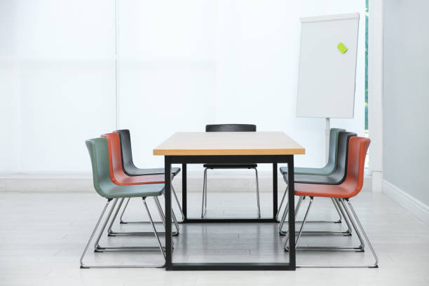 istock Conference room interior with wooden table and flipchart 1387631296