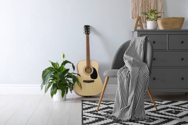 istock Chair with soft plaid in stylish room interior 1387632045