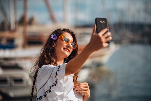 Woman in White Dress Taking Selfie