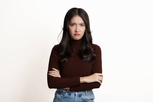 studio portrait photo of young asian woman with anger face expression on white background. - beautiful female displeased furious imagens e fotografias de stock