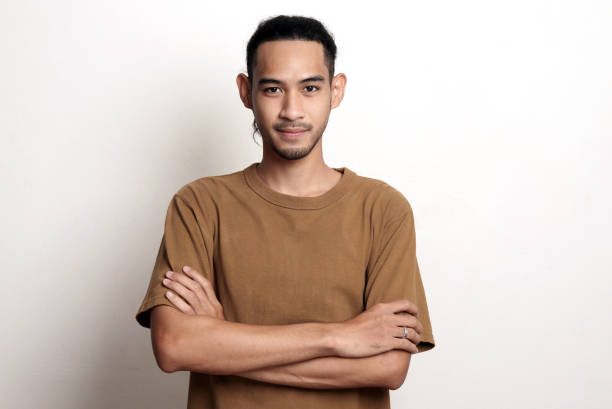 studio portrait photo of young asian man with anger face expression on white background. - dull colors imagens e fotografias de stock