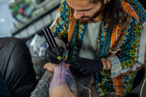 istock Artist tattooing a man in studio 1387634917