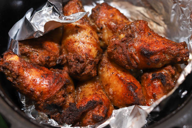 istock Cooked Chicken wings in a air fryer on a kitchen counter