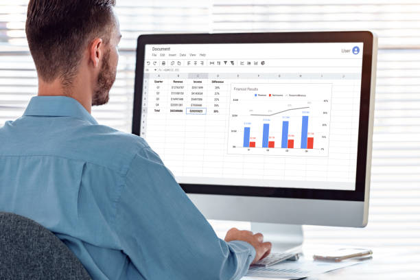 istock Accountant working on financial report and charts with spreadsheet software on computer at modern office. Data analysis, bookkeeping, auditing. 1387636862