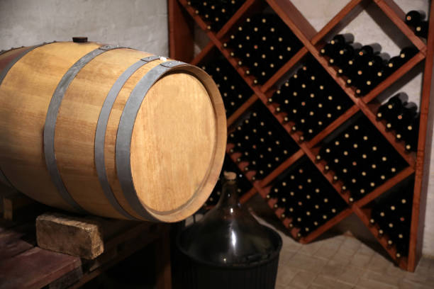 istock Large wooden barrel on table in wine cellar 1387638691
