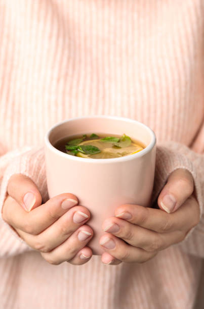 istock Woman holding cup with hot tea, closeup 1387638724