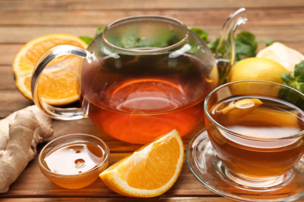 istock Hot tea, honey, ginger and citruses on wooden table 1387638731