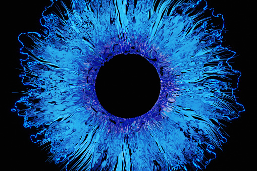 Abstract blue iris with glowing turquoise liquid, CGI.