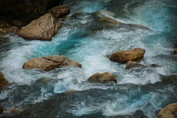 A long exposure image that blurs the motion of a flowing river.