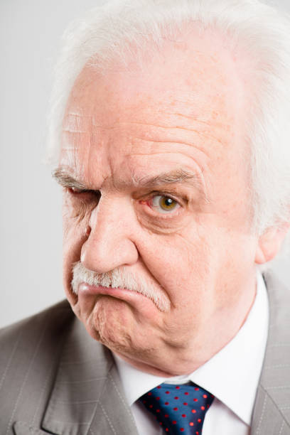 istock Shot of a senior man standing alone in the studio and looking skeptical 1387643496