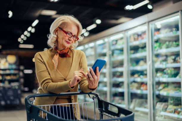 istock Woman checking shopping list on her cellphone 1387645185