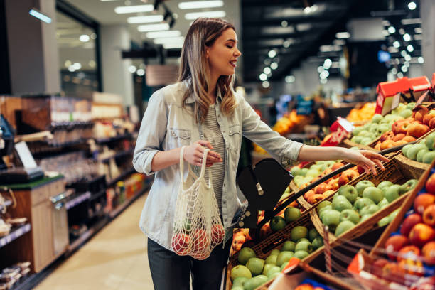 Young cheerful woman at the market stock photo