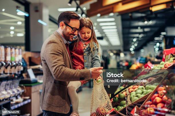 Cute Single Father And His Daughter In Shopping Stock Photo - Download Image Now - Supermarket, Retail, Family