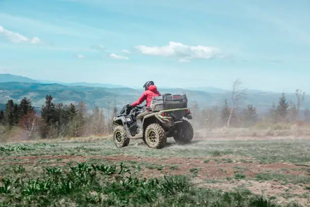 driving by mountain road at all-terrain vehicle. summer sunny day