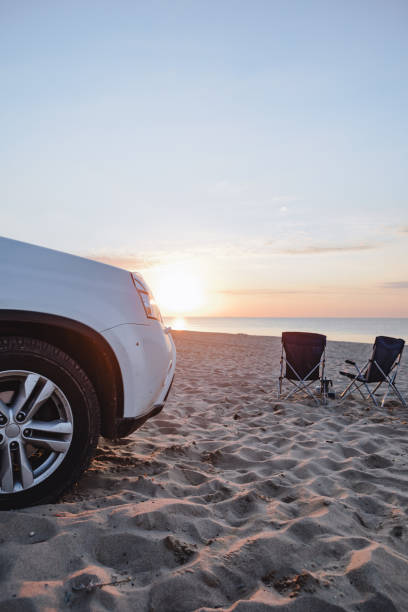 istock car at sandy beach near camping chair 1387647697