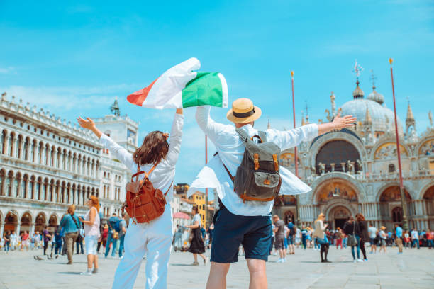 istock couple holding italian flag venice central square san marco 1387647721