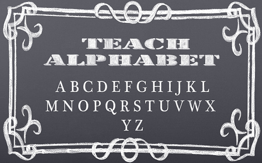 Decorative alphabet letters drawn on chalkboard. Letters written in chalk