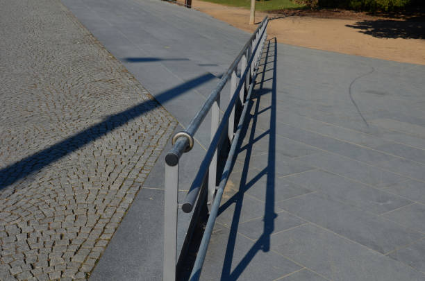 istock railing with two handrails. made of galvanized steel prisms. the lower railing is a protection against wheelchairs. ramp for the immobile in the housing estate, stainless steel, staircase, ramp 1387649466
