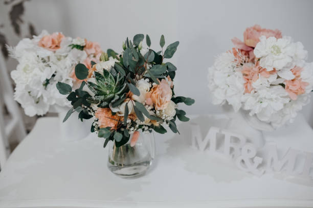 Close up wedding decoration Close up wedding decoration from white flowers peonies and roses and wood letters mr & mrs pink memorial candle with flowers stock pictures, royalty-free photos & images