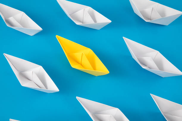 Yellow Paper Boat Leading Other Boats