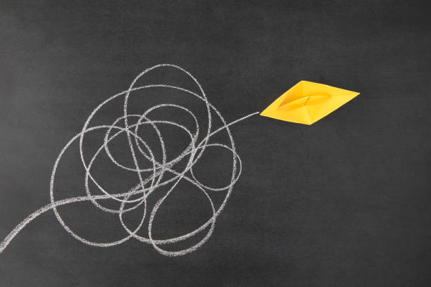 istock Paper Boat Sailing out of Tangled Path 1387653672