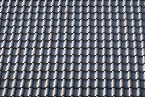 old wooden shingle on rooftop with blue sky.