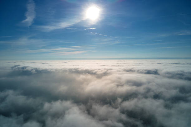 istock Aerial view from high altitude of earth covered with puffy rainy clouds forming before rainstorm 1387656045