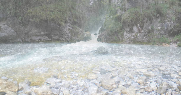 the heavy rain falls into a strong flowing waterfall in the rainforest - keyarena imagens e fotografias de stock