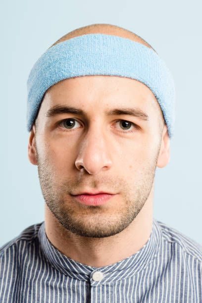 istock Shot of a handsome young man standing alone in the studio and posing while wearing a headband 1387657988