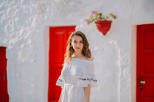 Woman Tourist in White Dress in Aegean Seaside Town