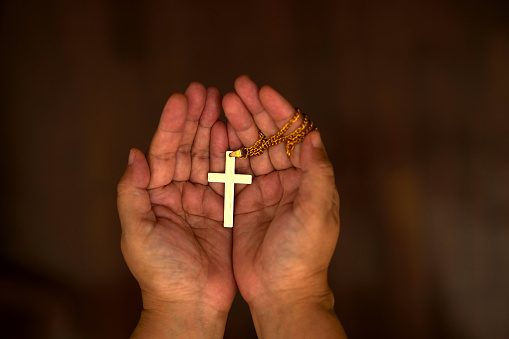 Hand holding a cross, Hope and pray concept