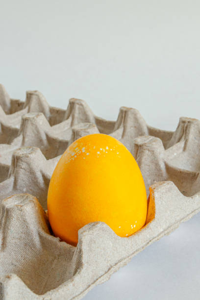 istock Happy Easter holiday. One yellow egg on a cardboard stand. 1387661997