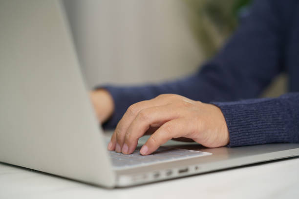 istock Woman hands Using Laptop Working on desk office 1387662101