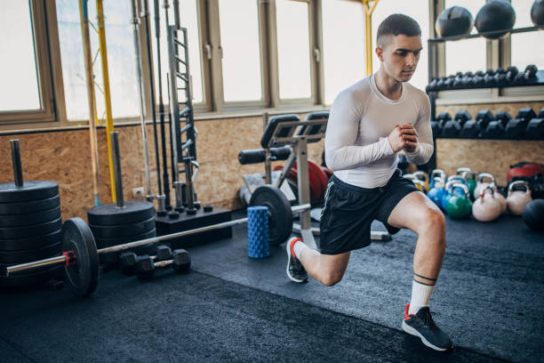 istock Handsome man exercising in gym 1387663611
