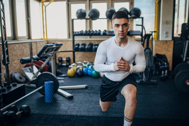 istock Handsome man exercising in gym 1387663650