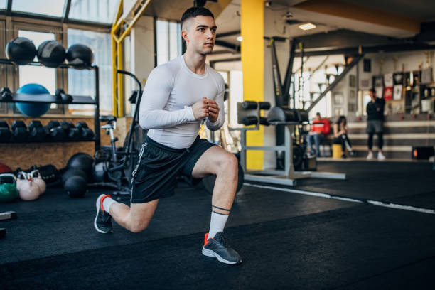 istock Handsome man exercising in gym 1387663668