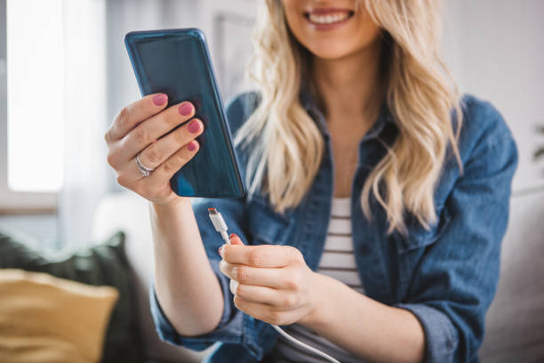 istock Woman charging power to smart phone. 1387664064
