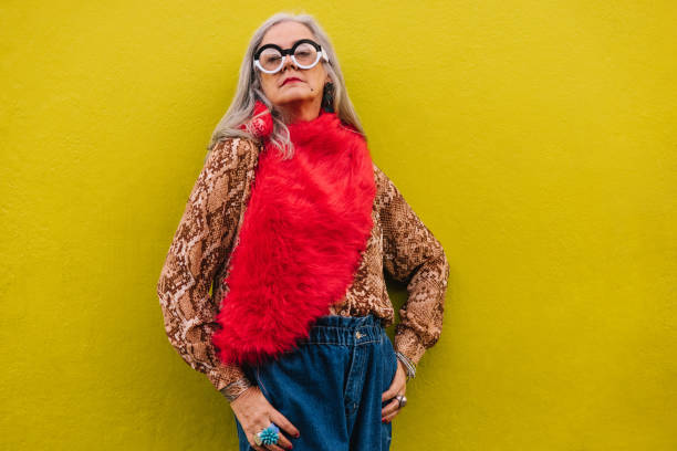 istock Confident senior woman standing against a lemon background 1387666167