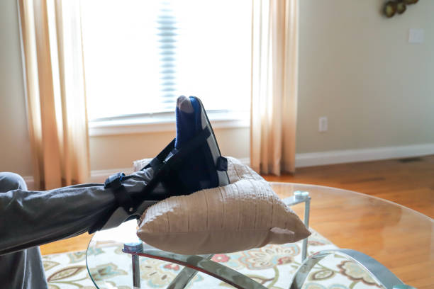 A man wearing a foot brace boot on his broken foot stock photo