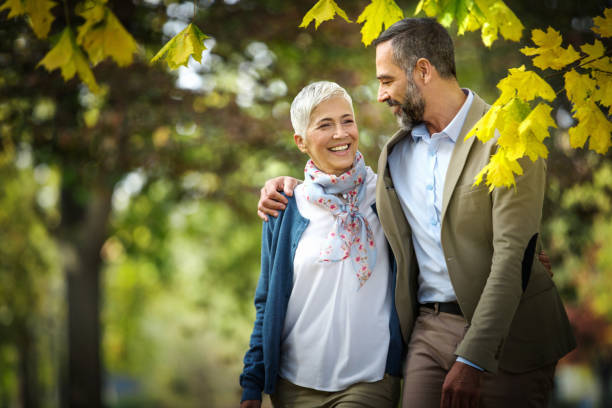 istock Mature couple walking through a park. 1387666290