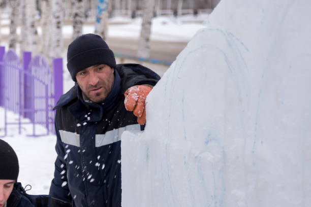 istock Workers are assembling ice blocks on the frame of a wooden slide 1387667847
