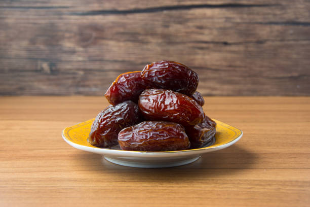 istock Delicious medjool dates ( kurma ) or sweet dried dates on a plate 1387667978
