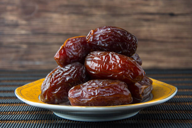 istock Delicious medjool dates ( kurma ) or sweet dried dates on a plate 1387668041