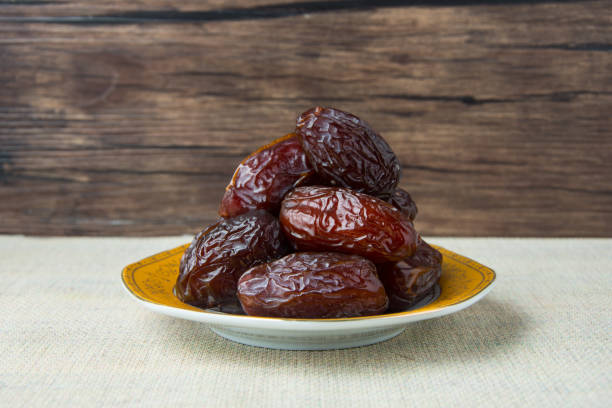istock Delicious medjool dates ( kurma ) or sweet dried dates on a plate 1387668810