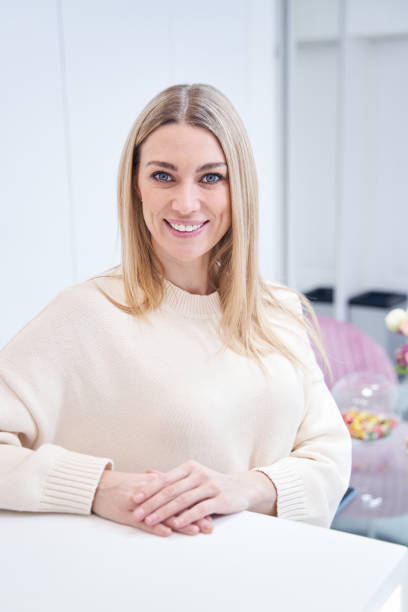 istock Smiling pleased spa customer waiting at inquiry counter 1387668866